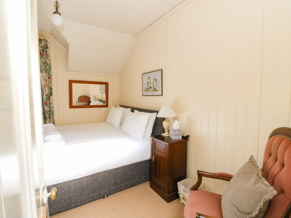 A bedroom with a bed and chair at West House in Stanley