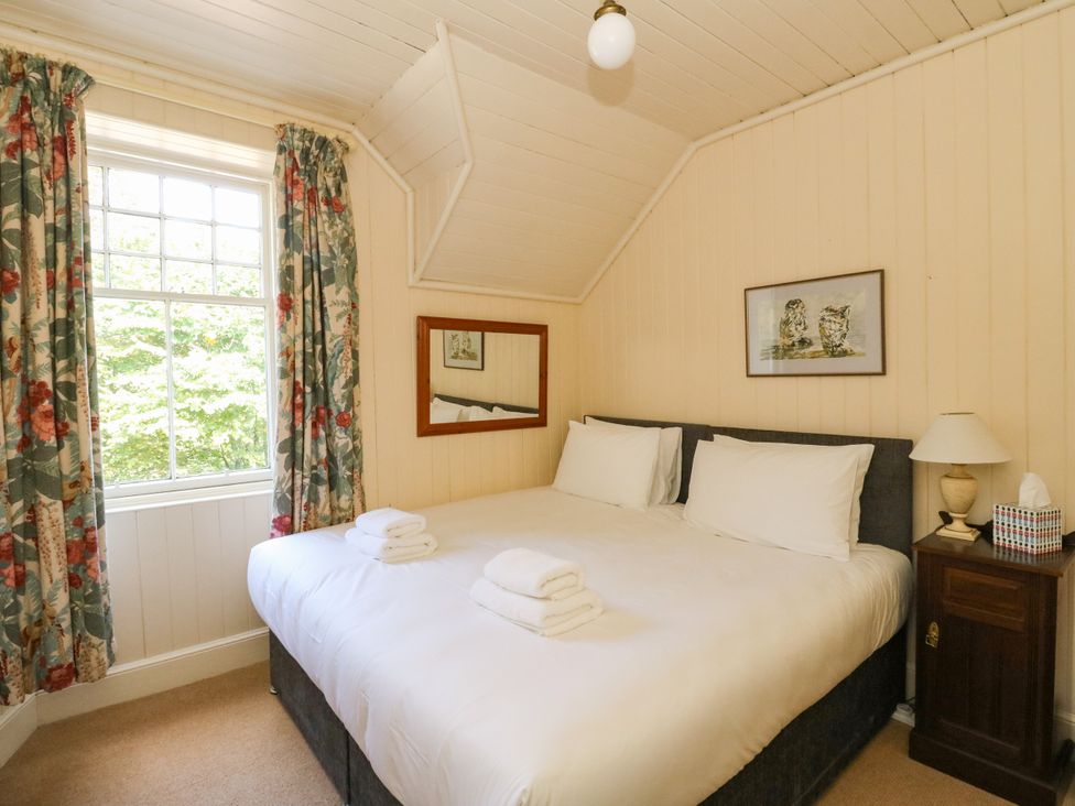 A bedroom with a bed and window at West House in Stanley