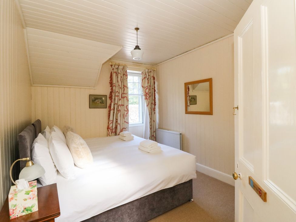 A bedroom with a bed and bedside table at West House in Stanley
