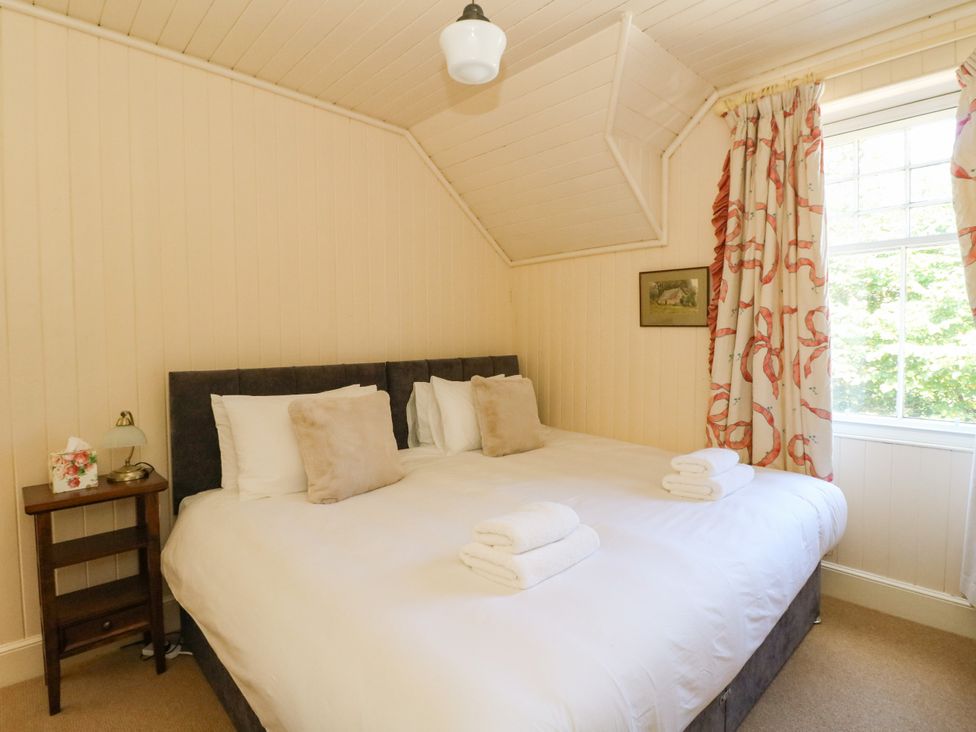 A bedroom with a bed and nightstand at West House in Stanley