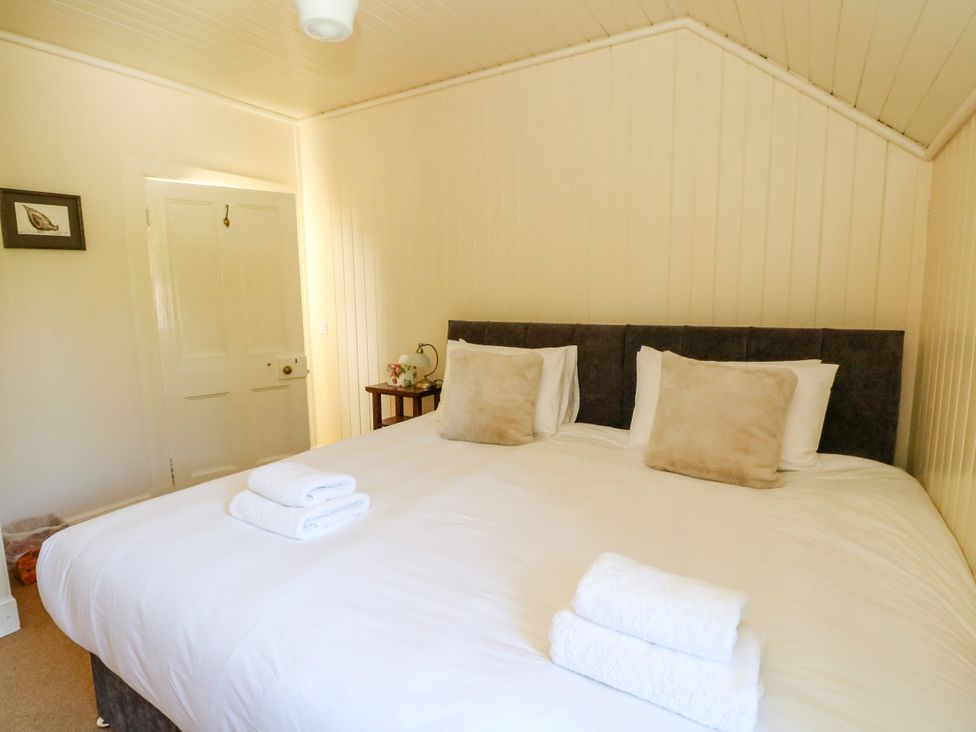 A bedroom with a double bed and towels on the bed at West House in Stanley