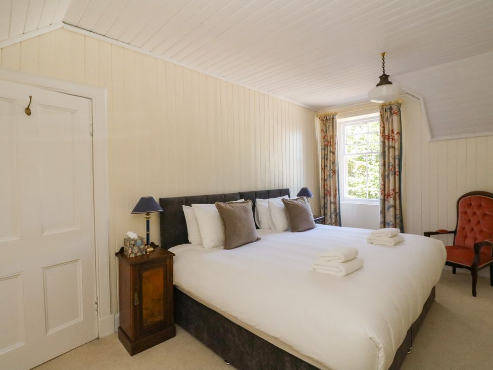 A bedroom with a bed and bedside table at West House in Stanley