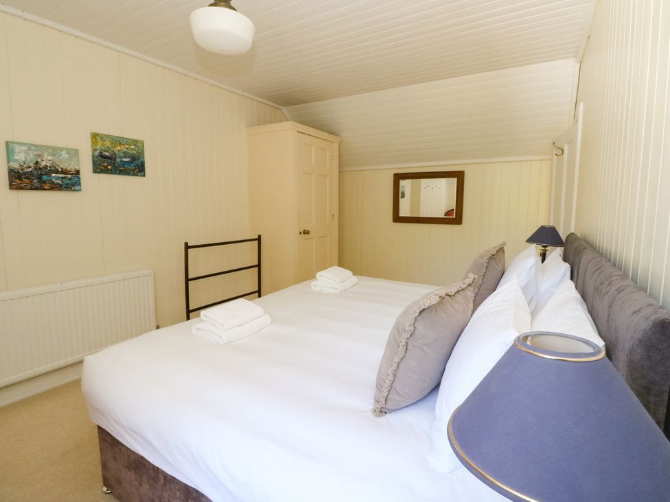 A bedroom with a double bed and wardrobe at West House in Stanley