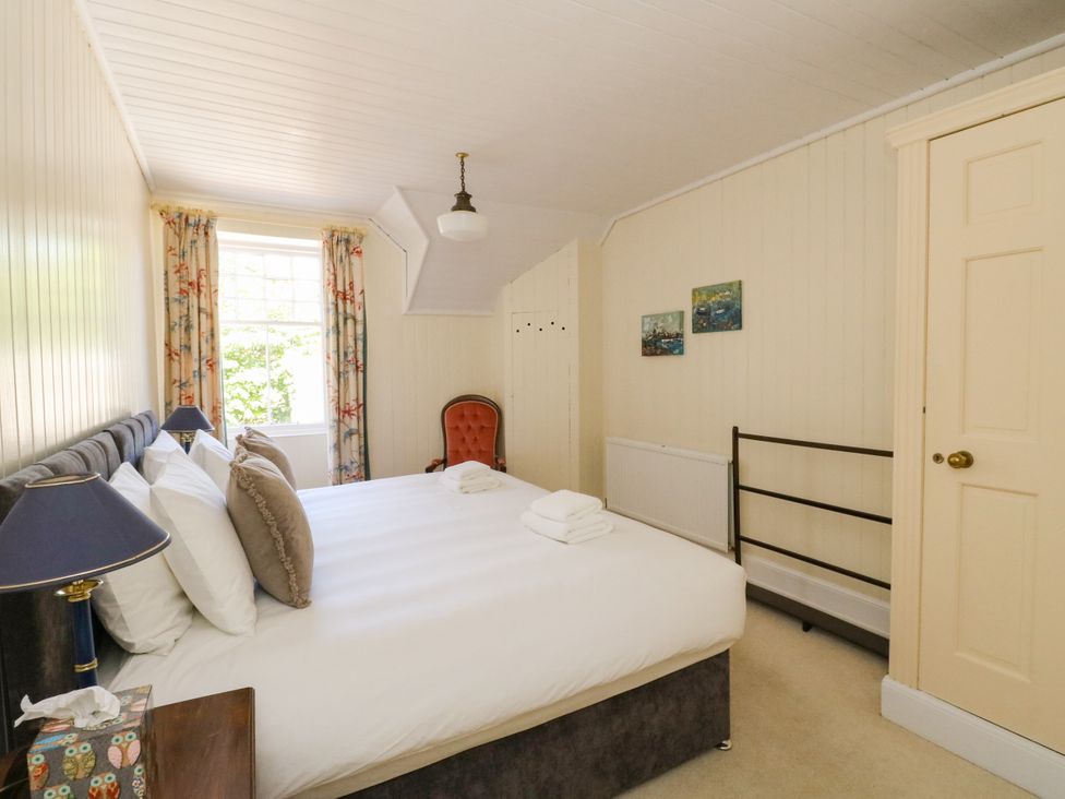 A bedroom with a bed and a chair at West House in Stanley