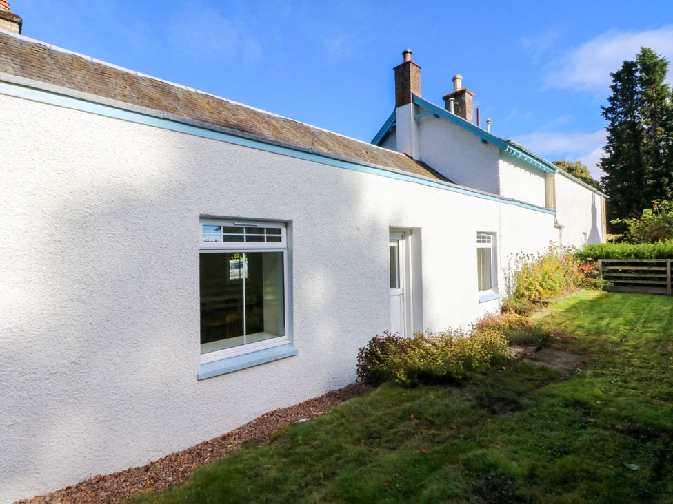 A view of a house exterior with windows and grass at West House in Stanley