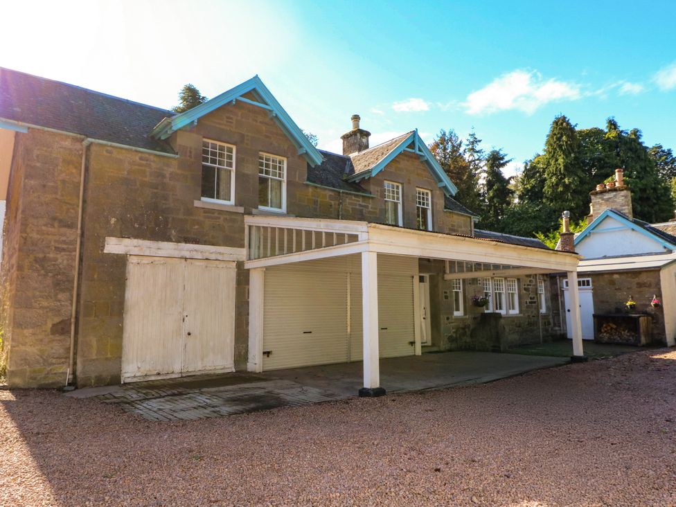 A house with a garage and wooden features at West House in Stanley