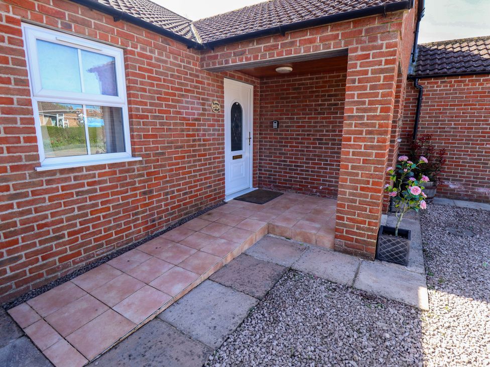 An entryway with a door and window at Rowan Cottage in Boston