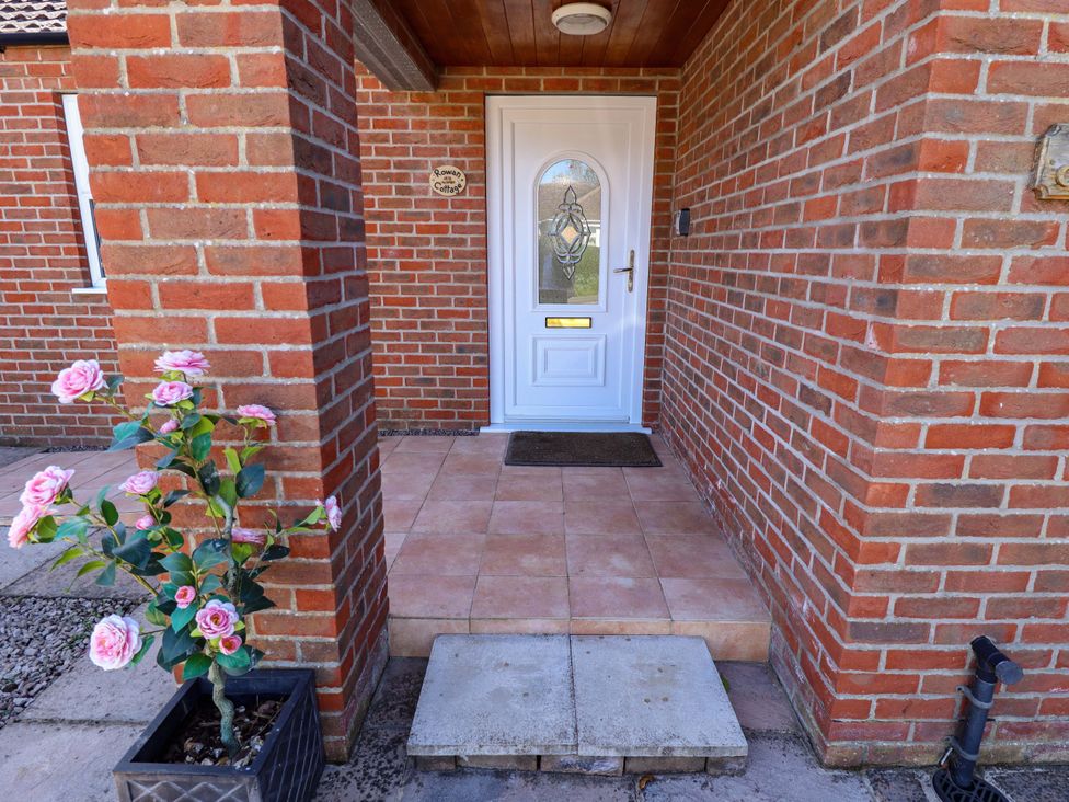 An entrance area with a front door and potted plant at Rowan Cottage in Boston