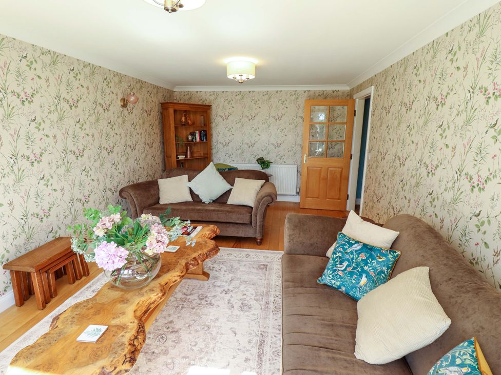 A living room with a sofa and coffee table at Rowan Cottage in Boston