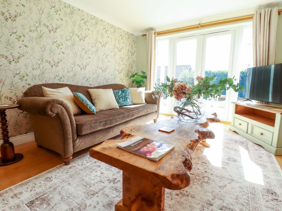 A living room with a sofa and a coffee table at Rowan Cottage in Boston