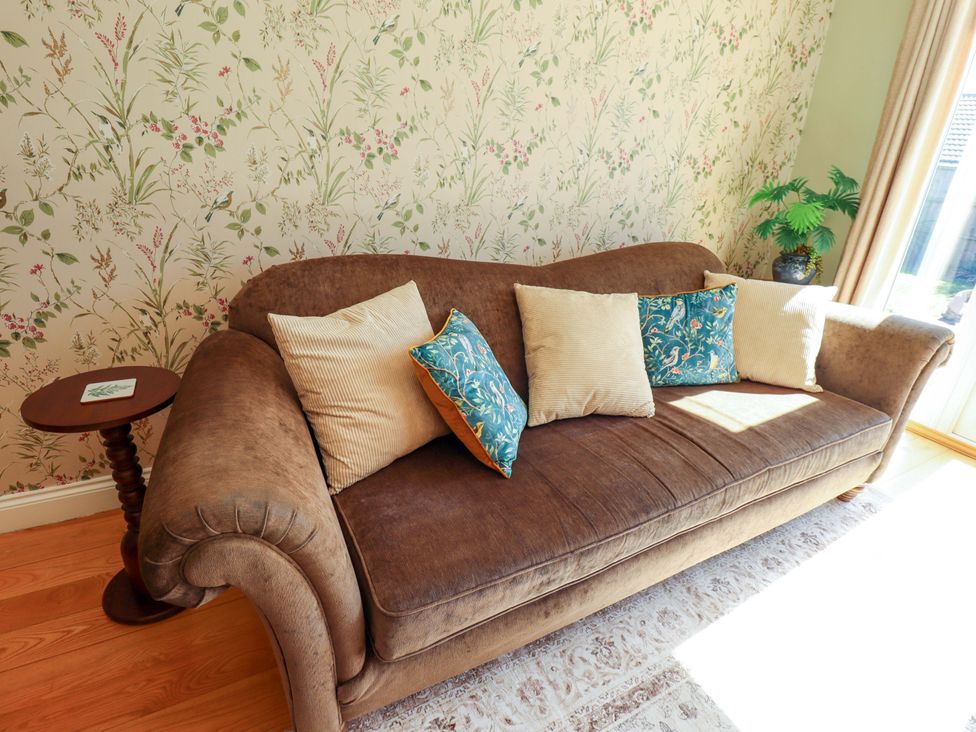 A living room with a sofa and side table at Rowan Cottage in Boston