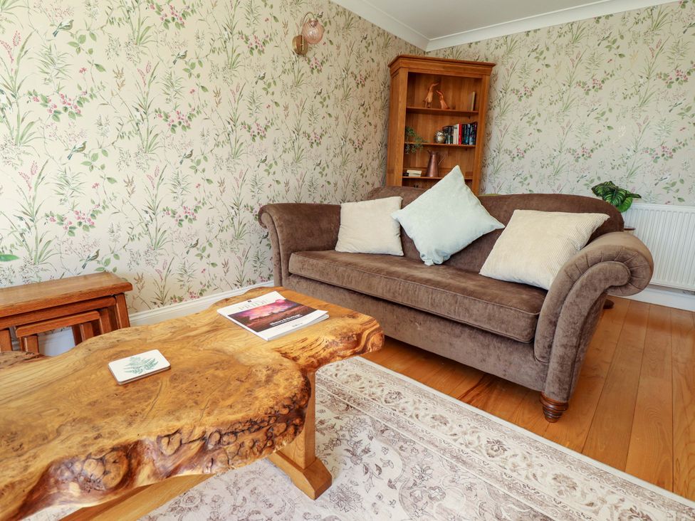 A living room with a sofa and a coffee table at Rowan Cottage in Boston