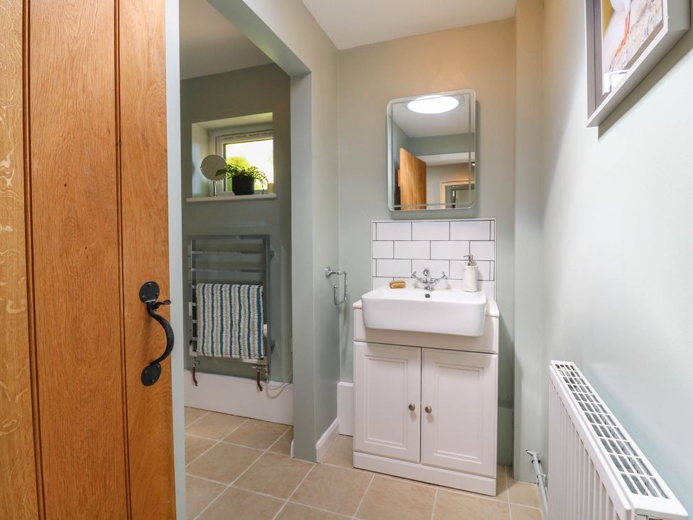 A bathroom with a sink and mirror at The Annexe @ Shotley Cottage in Shotley Gate