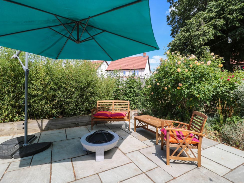 A garden with seating and a fire pit at The Annexe @ Shotley Cottage, Shotley Gate