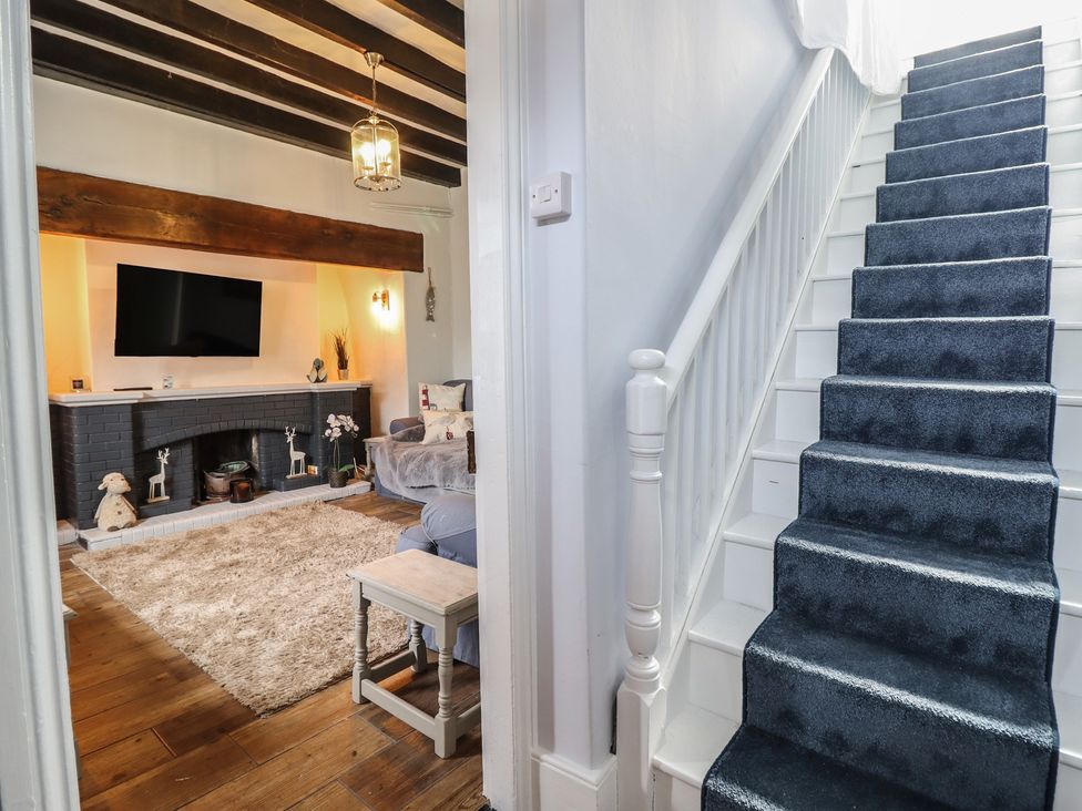 A living room with a fireplace and a sofa at Glanrafon