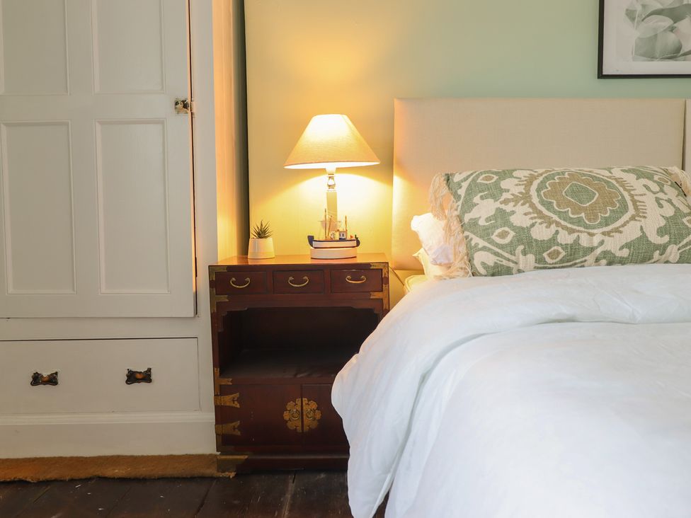 A bedroom with a bed and nightstand at Glanrafon 