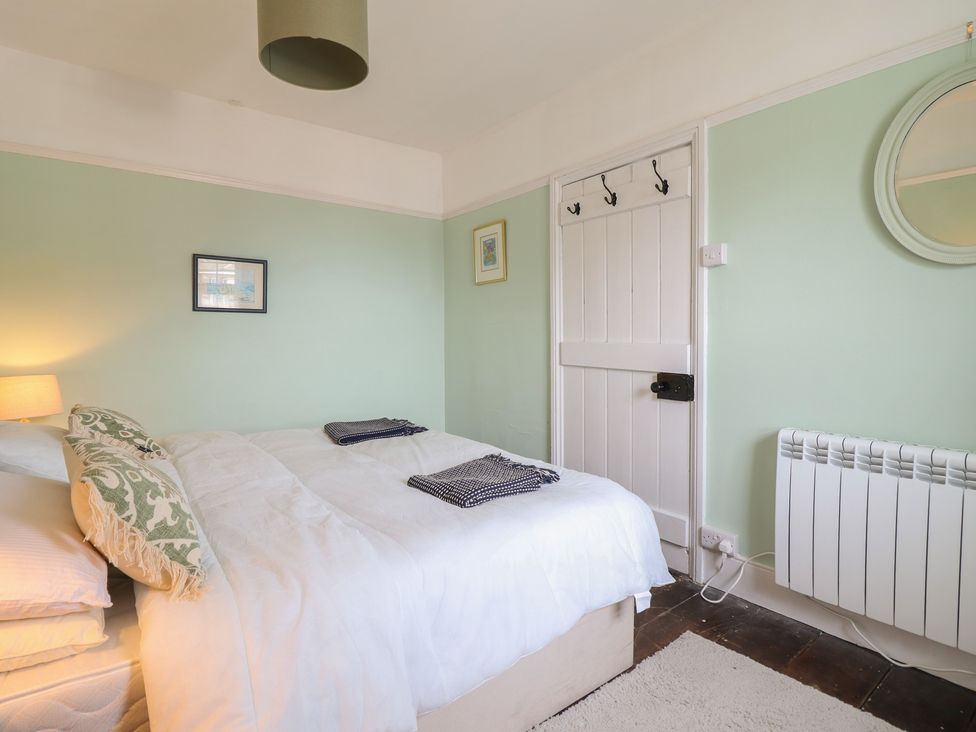 A bedroom with a bed and lamp at Glanrafon