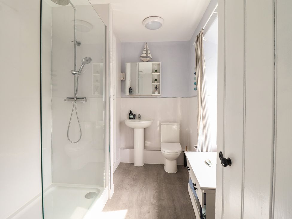 A bathroom with a shower, sink, and toilet at Glanrafon
