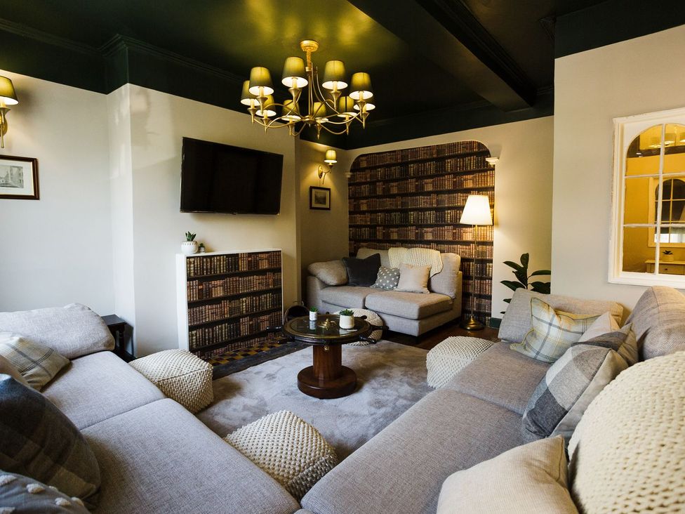 A living room with a sofa and coffee table at Admirals home