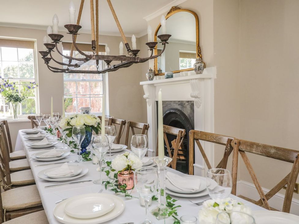 A dining room with a table set for a meal at Admirals home