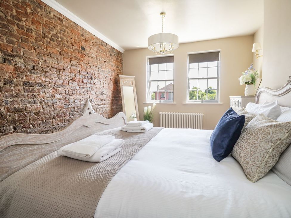 A bedroom with a bed and a mirror at Admirals home