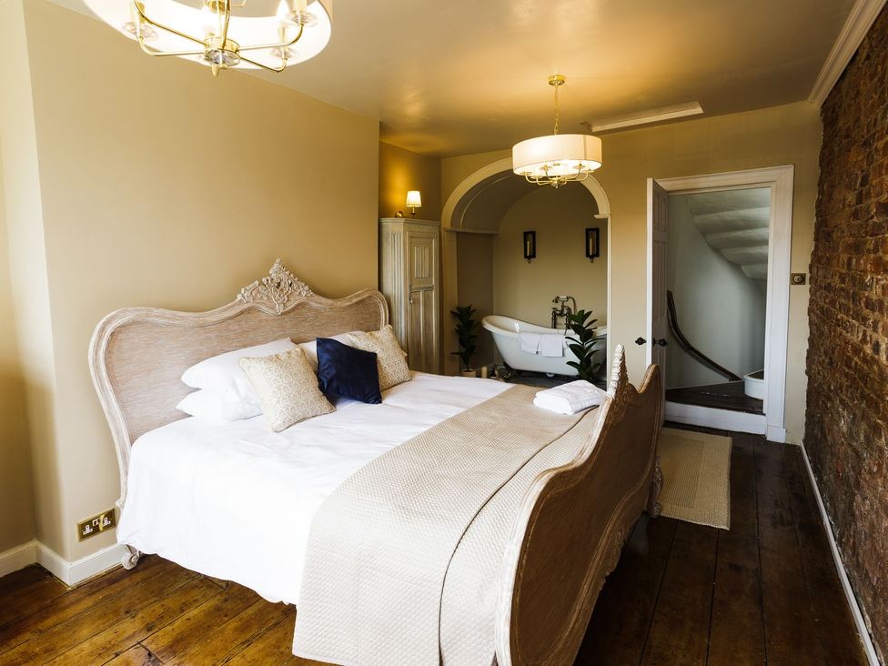 A bedroom with a bed and wardrobe at Admirals home