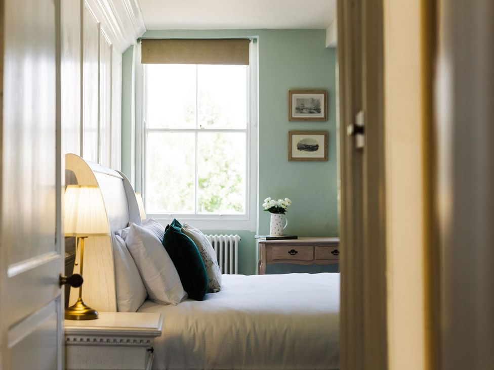 A bedroom with a bed and window at Admirals home