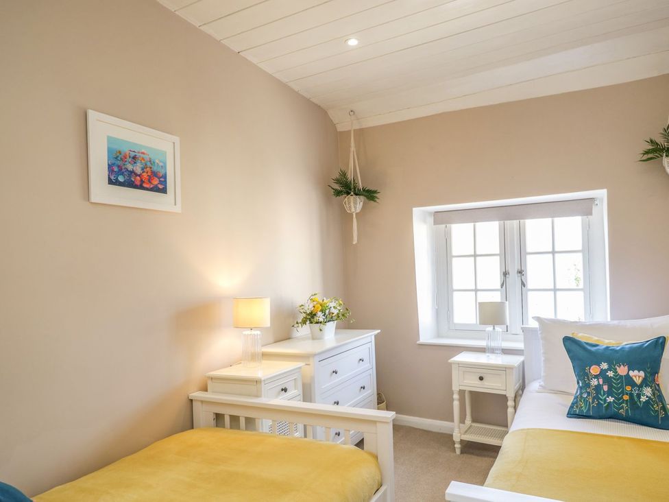 A bedroom with two beds and a nightstand at Admirals home