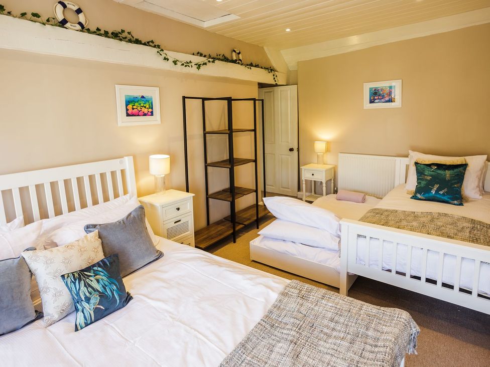 A bedroom with two beds and a shelf in Admirals home