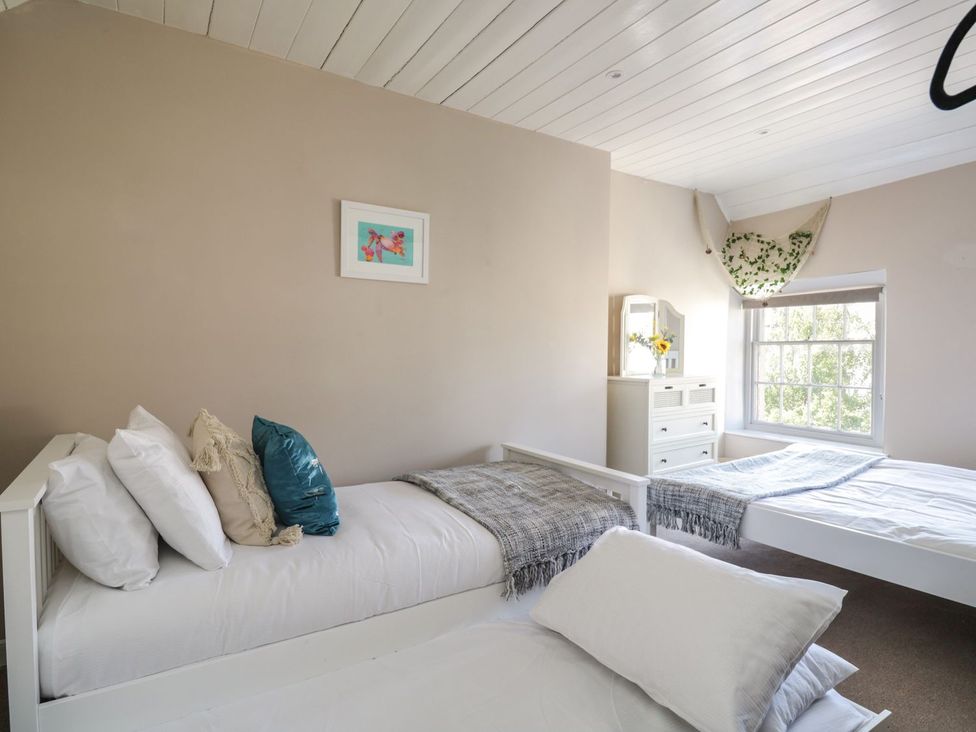 A bedroom with two beds and a dresser at Admirals home