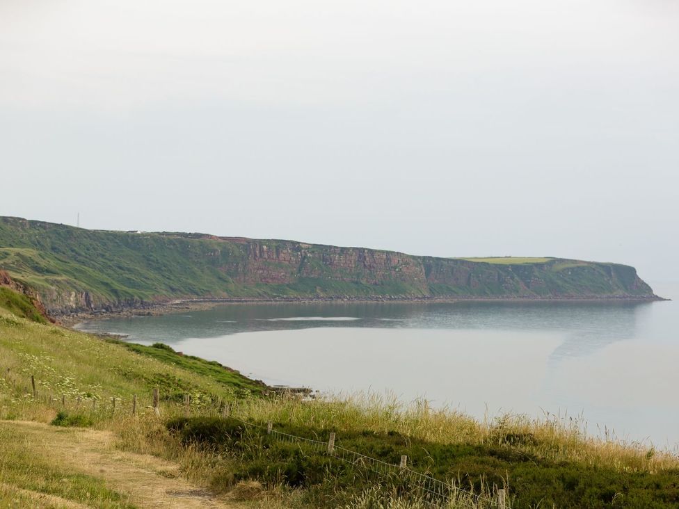 A coastal view of cliffs and ocean with grassland at Admirals home in 
