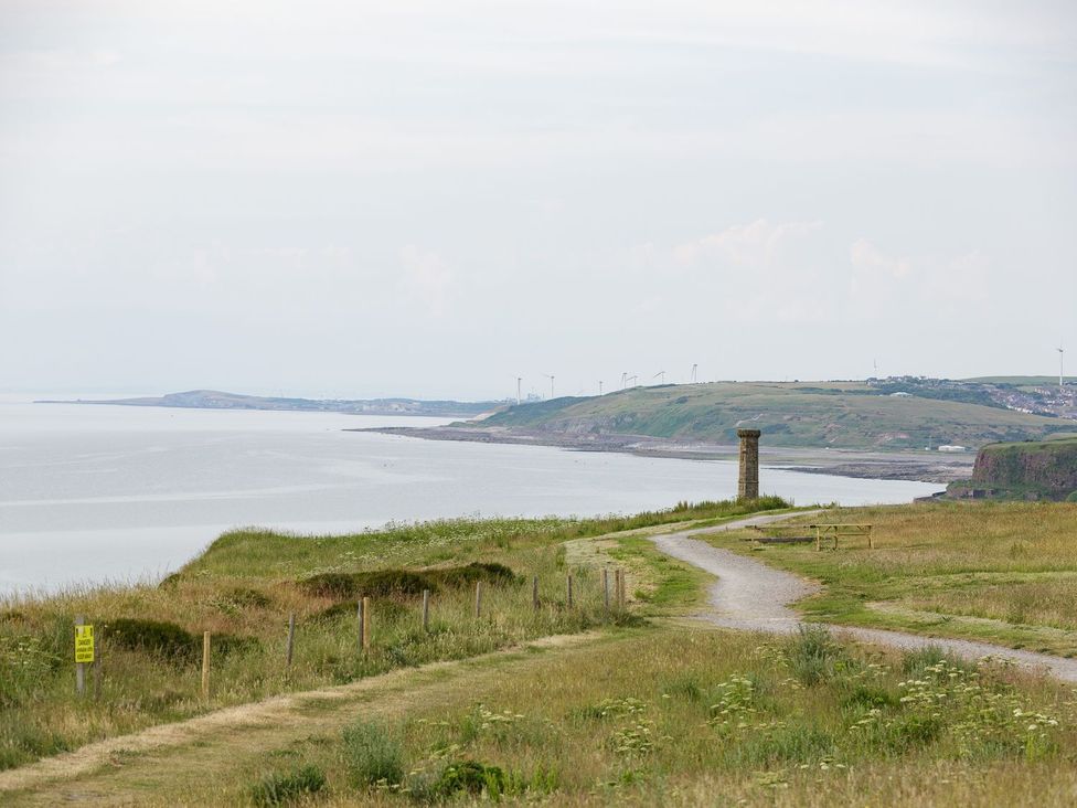 A coastal landscape with a path and a pillar at Admirals home