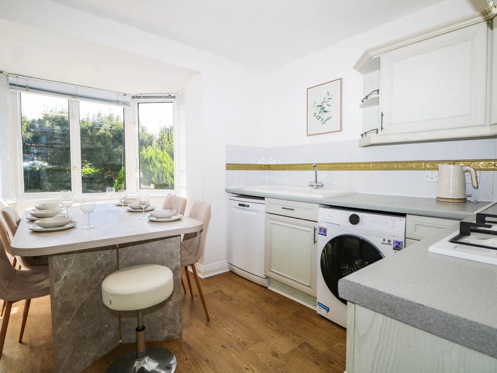A kitchen with a dining table and chairs at 4 Atlantic Close in Southampton