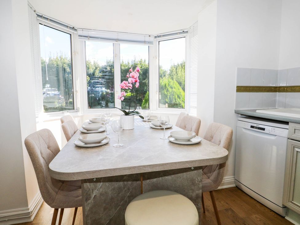 A dining room with a table set for meal at 4 Atlantic Close in Southampton