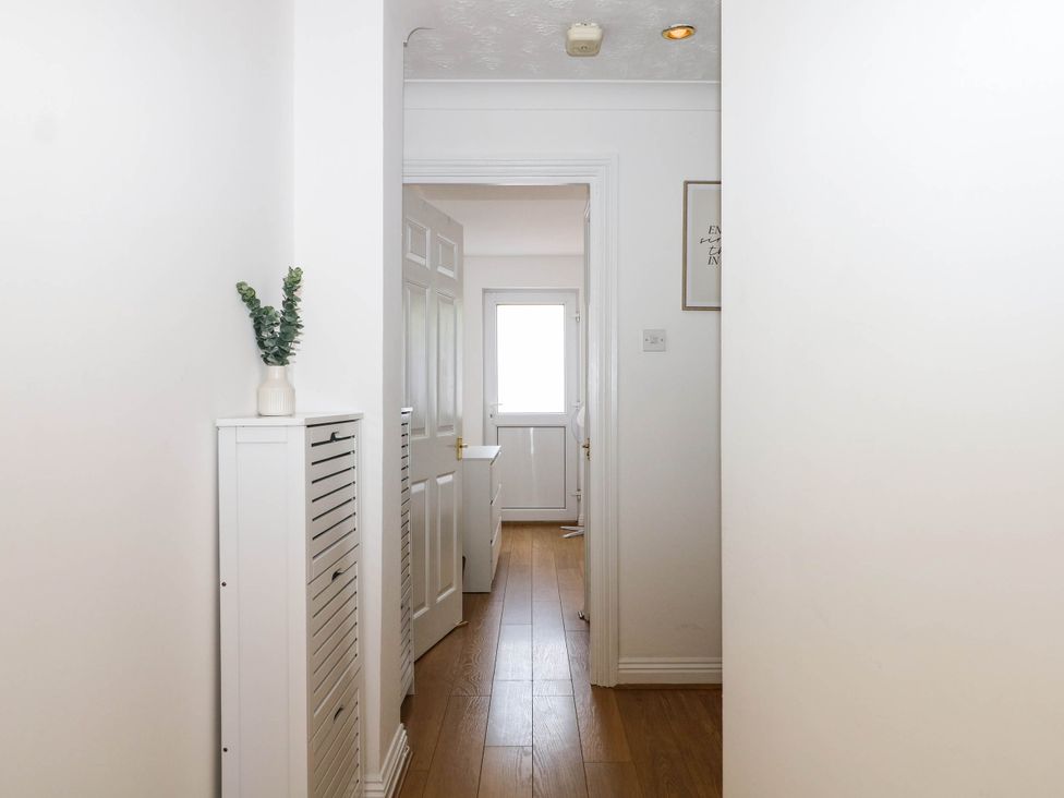 A hallway with a plant and door at 4 Atlantic Close Southampton