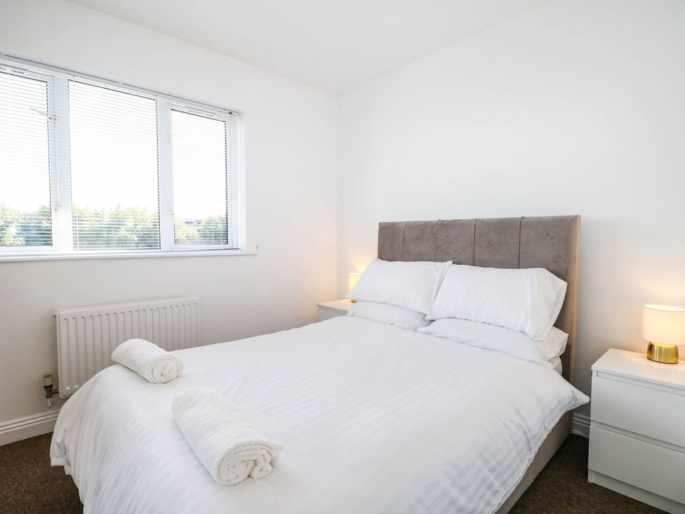 A bedroom with a bed and bedside tables at 4 Atlantic Close Southampton
