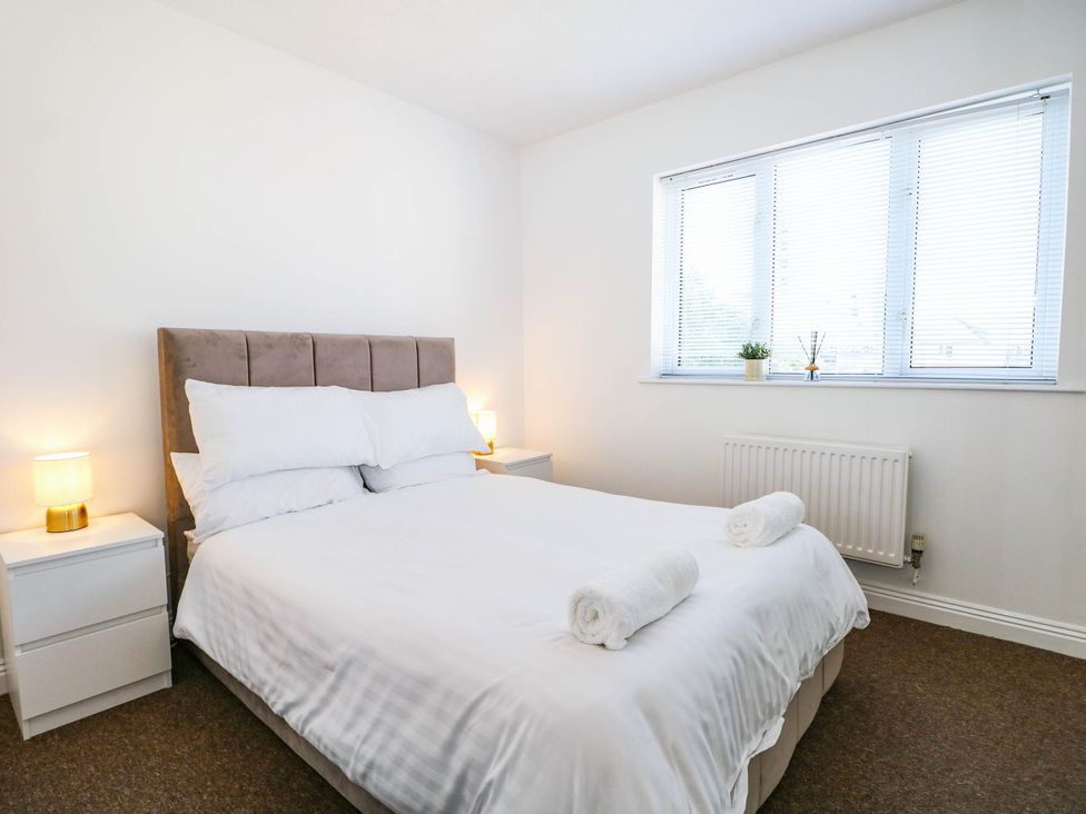 A bedroom with a bed and bedside tables at 4 Atlantic Close Southampton