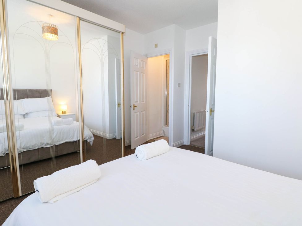 A bedroom with a bed and mirror at 4 Atlantic Close Southampton
