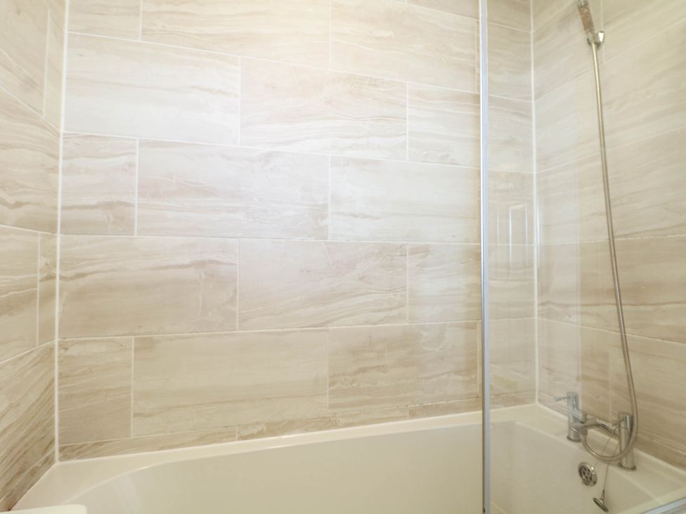 A bathroom with a bathtub and shower at 4 Atlantic Close Southampton