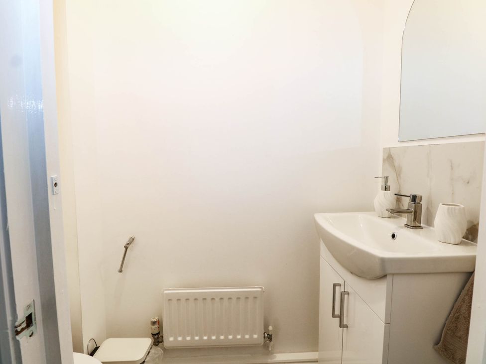 A bathroom with a sink and toilet at 4 Atlantic Close in Southampton