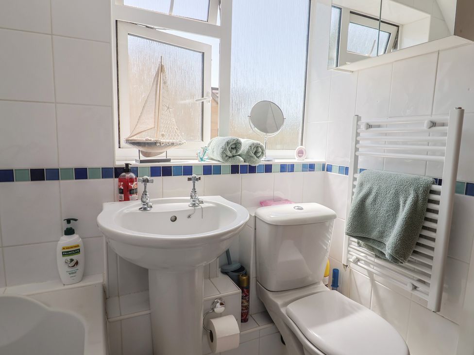 A bathroom with a sink and toilet at Tane in Winterborne Stickland