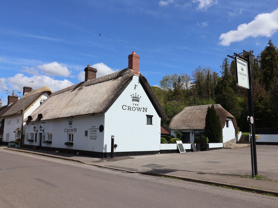 A thatched roof pub called The Crown at The Crown in Winterborne Stickland