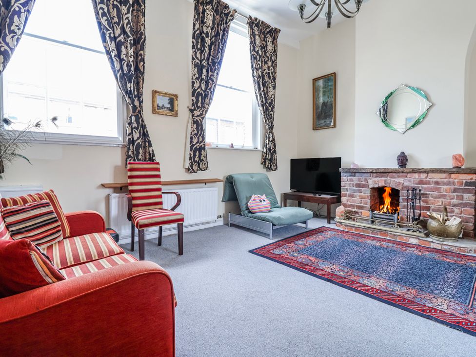 A living room with a sofa and television at Top floor apartment 