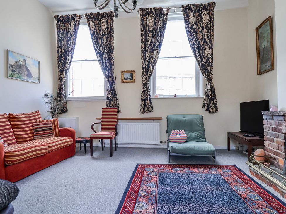 A living room with a sofa and a television in Top floor apartment 