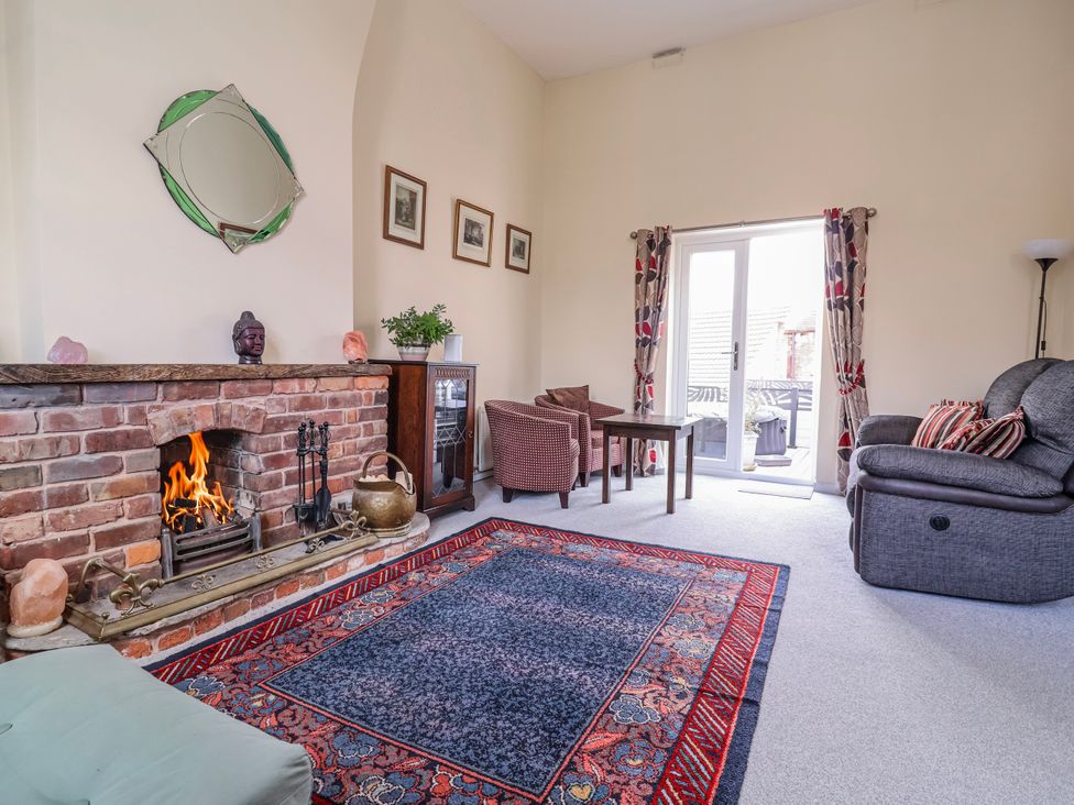 A living room with a fireplace and seating at Top floor apartment 