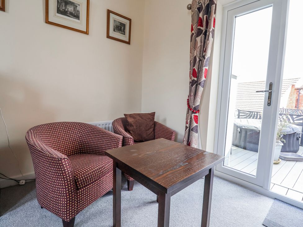 A snug with two armchairs and a table at Top floor apartment 
