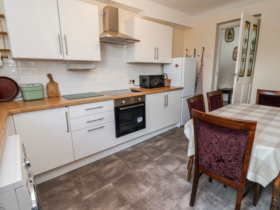 A kitchen with cabinets and appliances at Top floor apartment