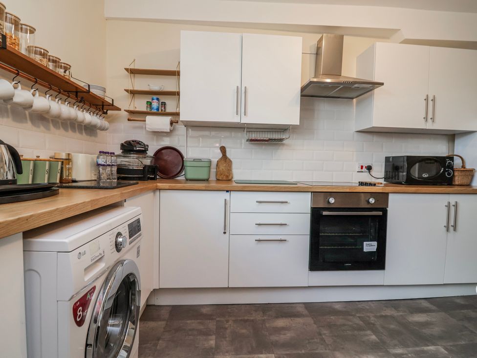 A kitchen with appliances and utensils at Top floor apartment