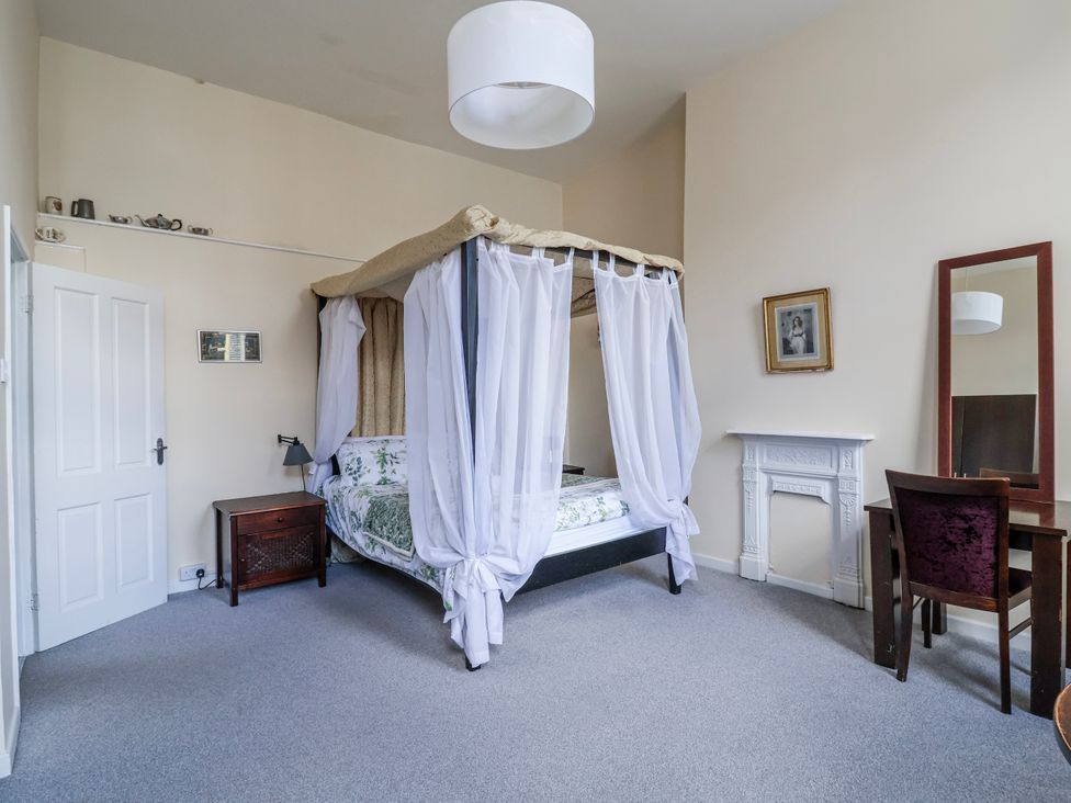 A bedroom with a canopy bed and nightstand at Top floor apartment 
