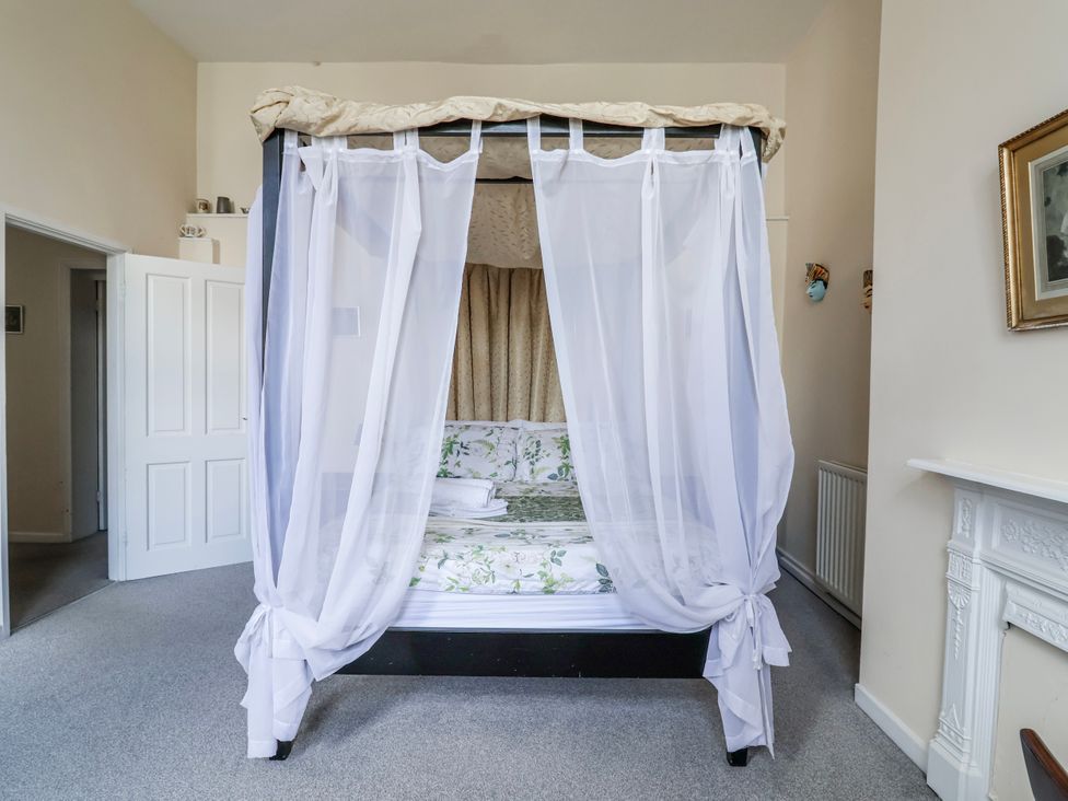 A bedroom with a canopy bed and door at Top floor apartment in 